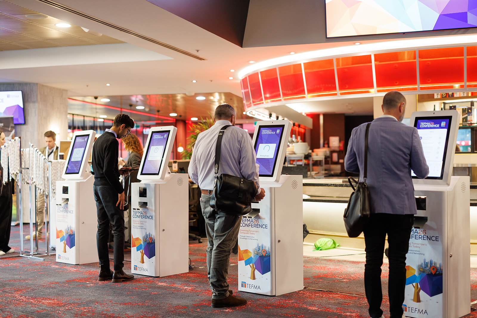 Delegates using self-service badge kiosks at the TEFMA26 Conference