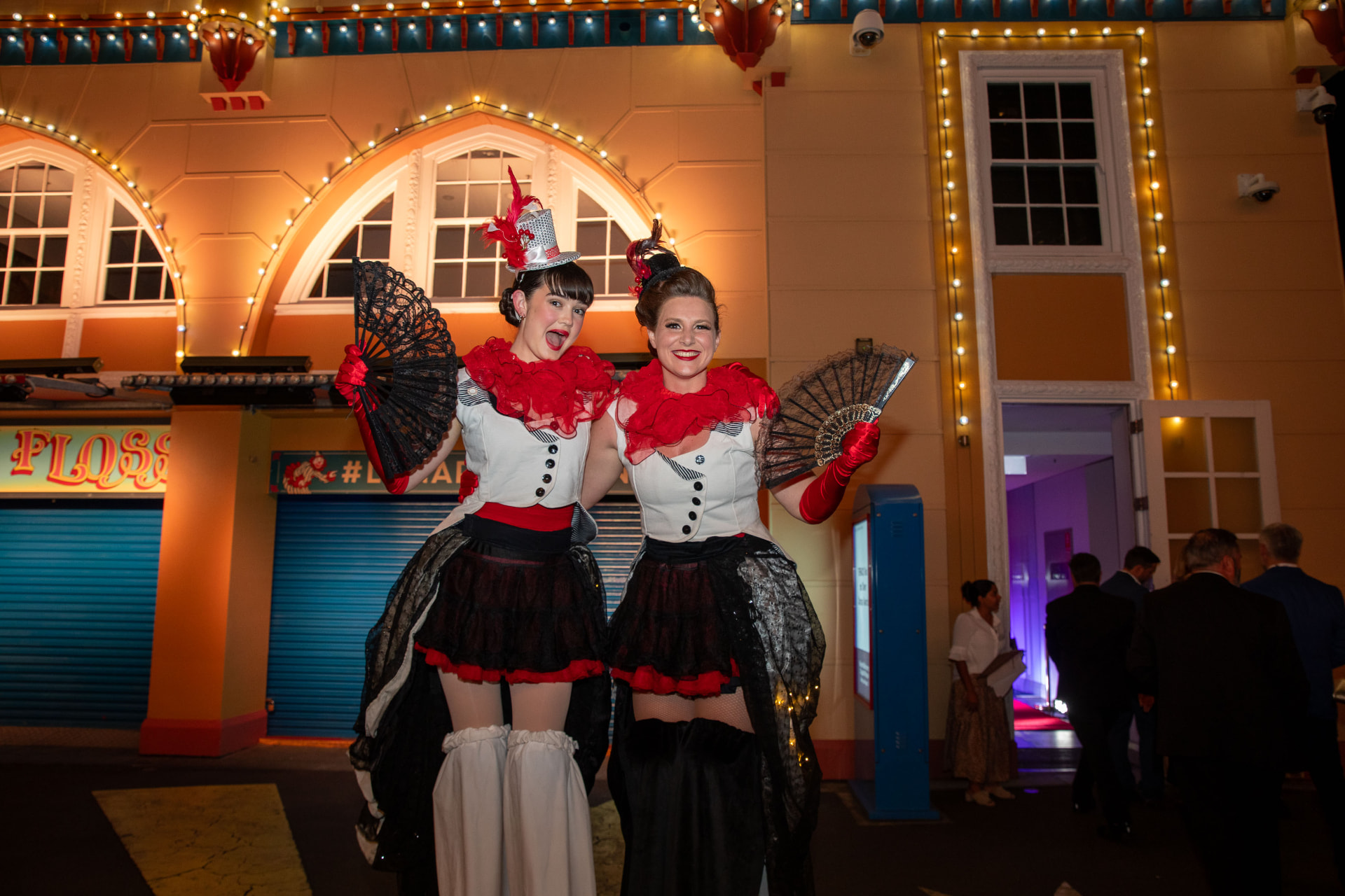 Costumed performers welcoming guests at an evening conference event